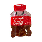 A single cute cola bottle hair clip with a smiling face.
