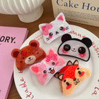 A top-down view of several animal-themed hair clips placed on a white plate with text in the background.