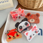 A collection of adorable animal hair clips, including a bear with a strawberry, a panda, a cat with a bow, a corgi with a bow, and a fox, displayed on a tray.