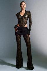 Model posing in a black lace ensemble.