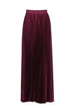 Close-up of a burgundy pleated maxi skirt.