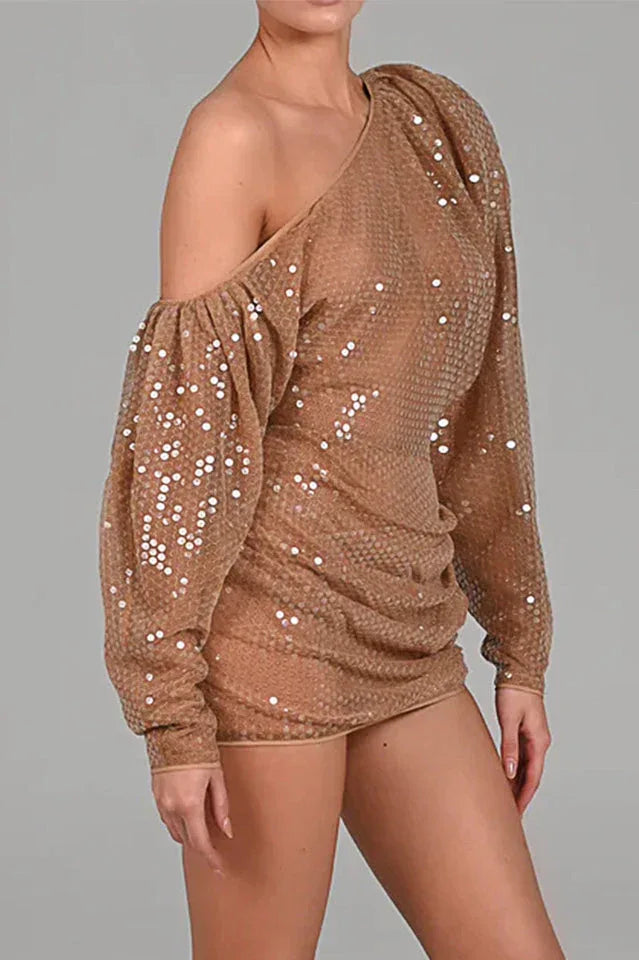 Side view of a woman in a shimmering sequined one-shoulder dress.