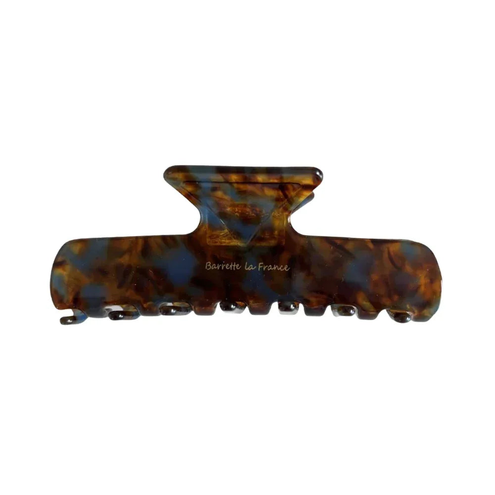 A tortoiseshell patterned hair claw clip with blue and brown swirls, against a white background.