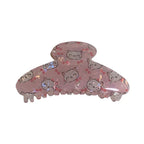 Pink claw clip with repeating cat faces and cherry blossoms.