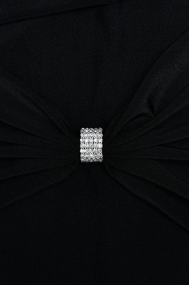 Close-up of the embellishment on the black maxi dress.