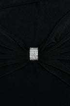 Close-up of the embellishment on the black maxi dress.