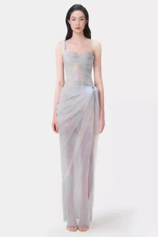 Model wearing a light blue sheer tulle gown with a one-shoulder design and corset bodice.