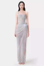 Model wearing a light blue sheer tulle gown with a one-shoulder design and corset bodice.