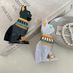 Black and white glitter Egyptian cat hair clips on a book with pearls