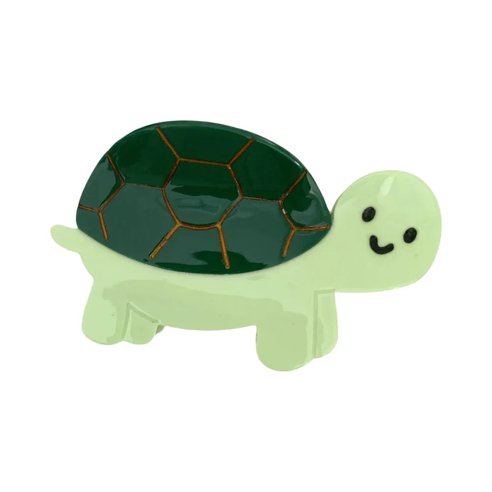 A close-up of a green cartoon turtle accessory with a dark green shell.