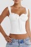 Front view of a white ruched corset top with a bow accent.