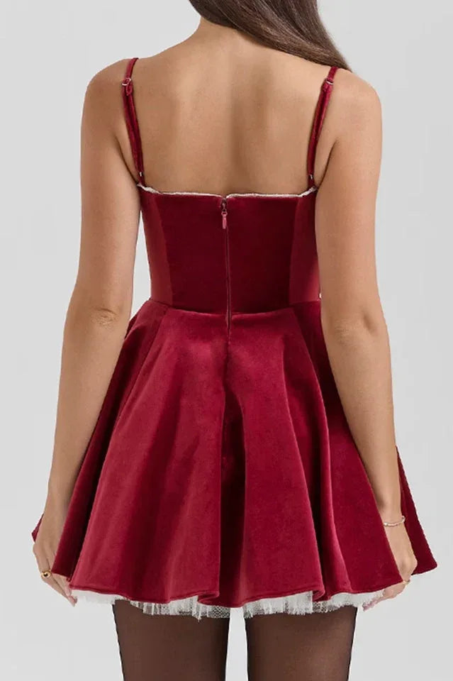 Rear view of a red velvet dress with a full skirt and lace hem.