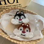 Two cartoon chipmunk face hair claw clips in a woven basket