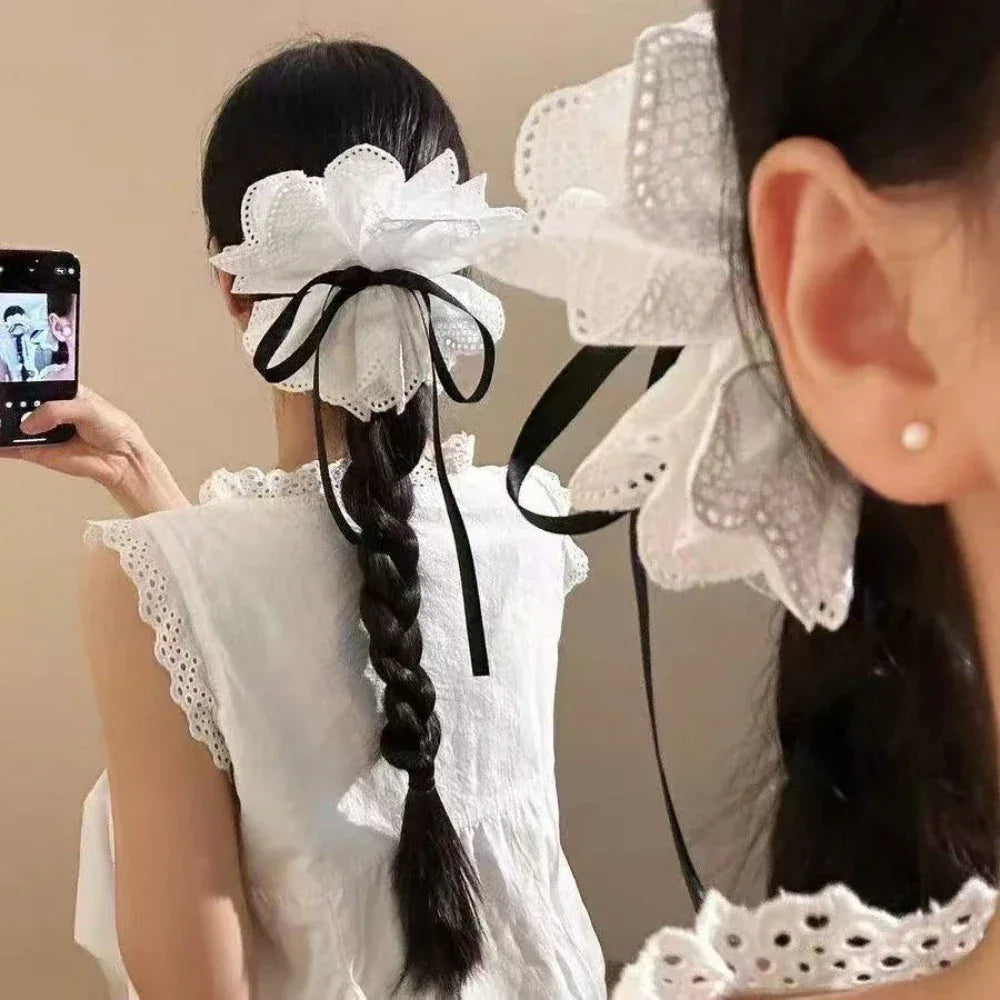 woman with braided hair wearing a white lace hair accessory