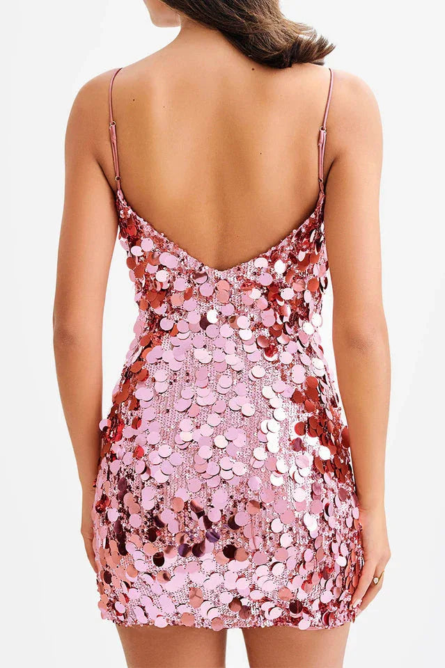 Back view of a pink sequined mini dress with spaghetti straps