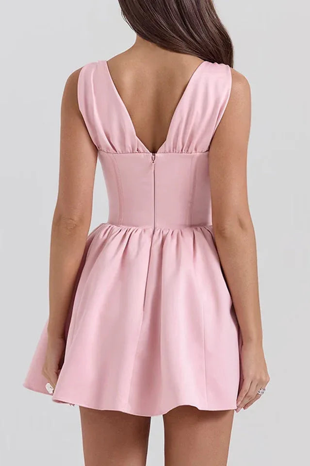 Pink sleeveless V-neck dress with a fitted bodice and flared skirt, back view showing zipper closure