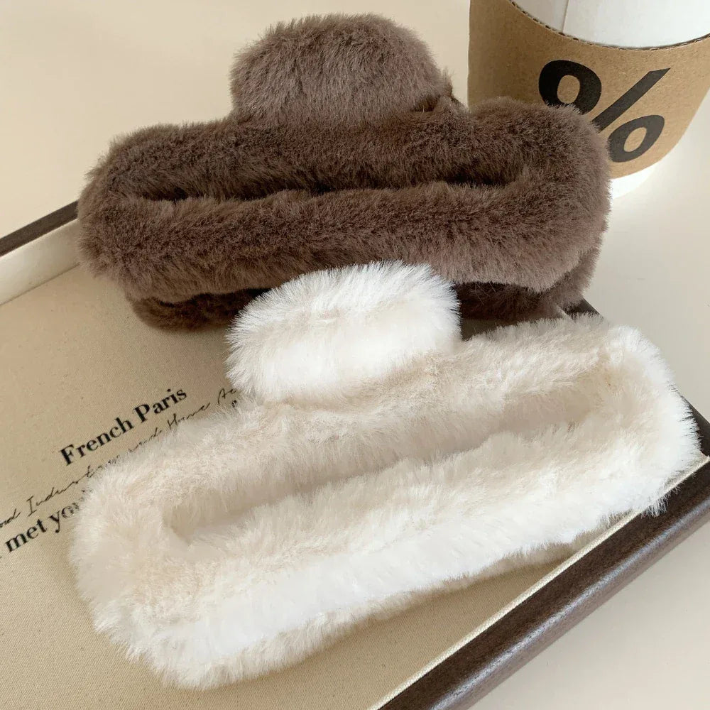 Brown and white faux fur claw clips on a tray with text