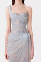 Back view of the model in the light blue tulle gown, highlighting the sheer fabric and column silhouette.