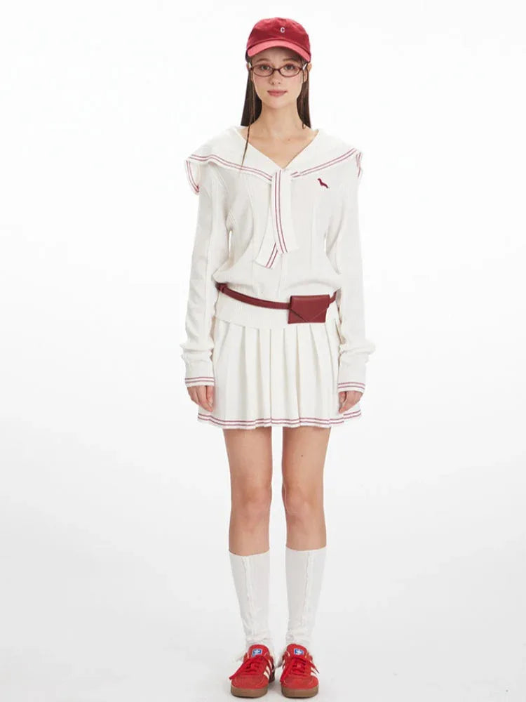 Model wearing a white knit sweater with a sailor collar and red trim, paired with a white pleated skirt, red belt bag, white socks, and red sneakers. Main image