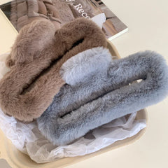 Brown and gray faux fur claw clips in a basket