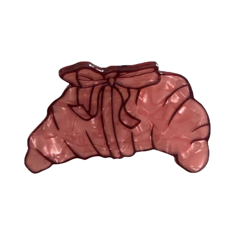pink acrylic croissant hair clip with bow detail Main image