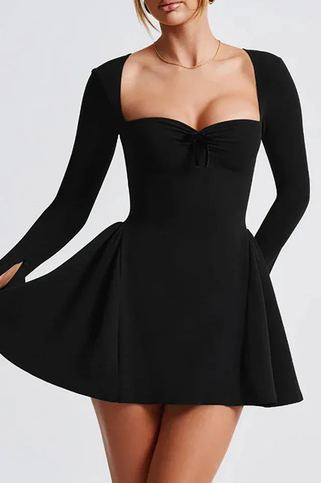Woman wearing a black long-sleeved square neck mini dress