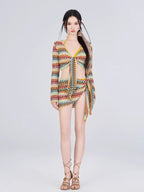 Full-length view of a woman in a crocheted knit outfit with a bikini