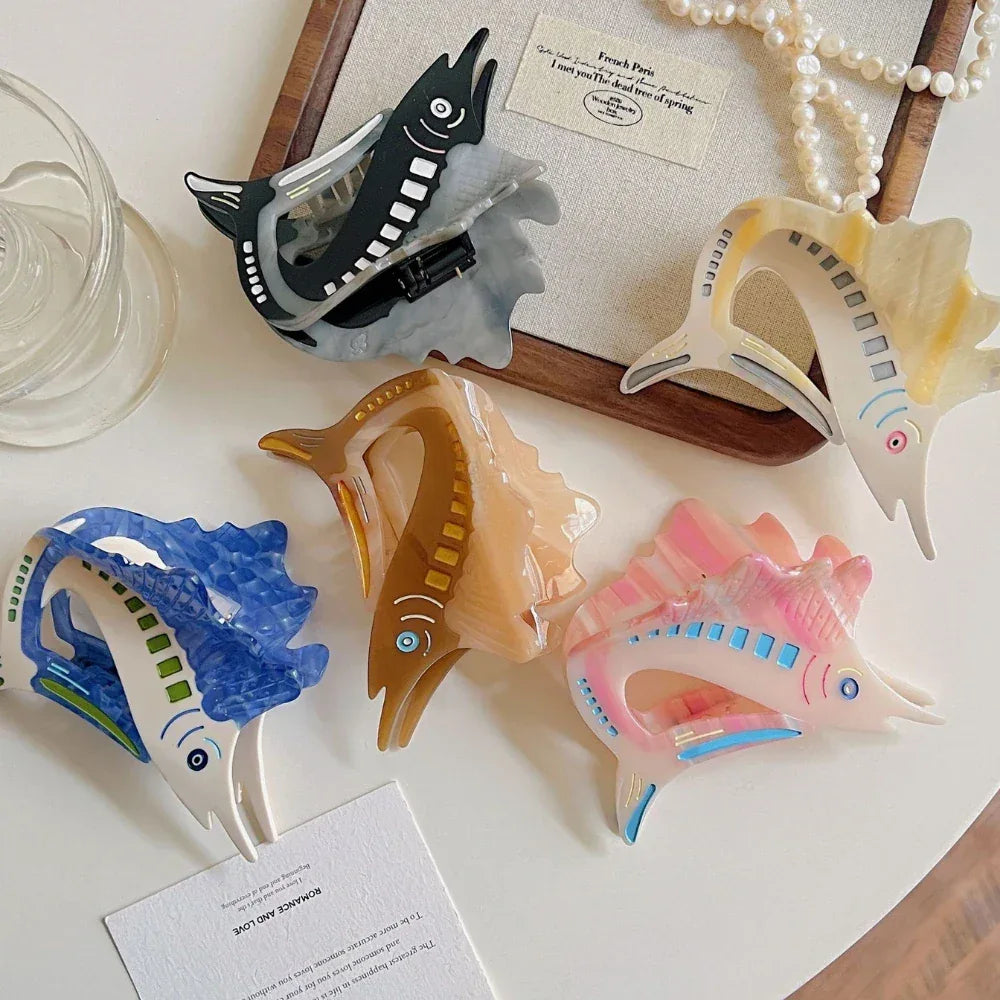 Assortment of decorative marlin hair clips arranged on a white surface