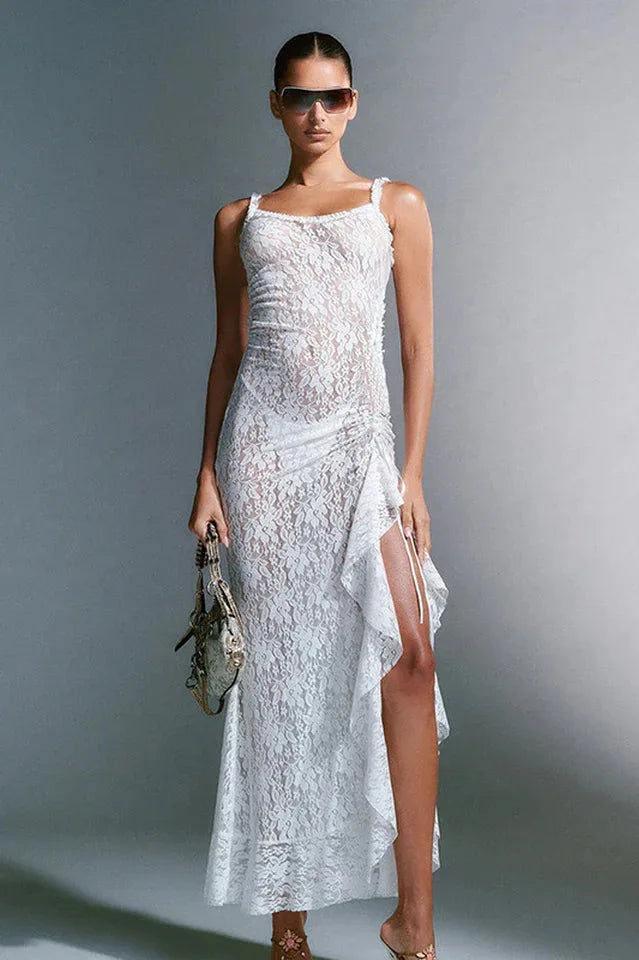 woman wearing a white lace maxi dress with a high slit and ruffles Main image