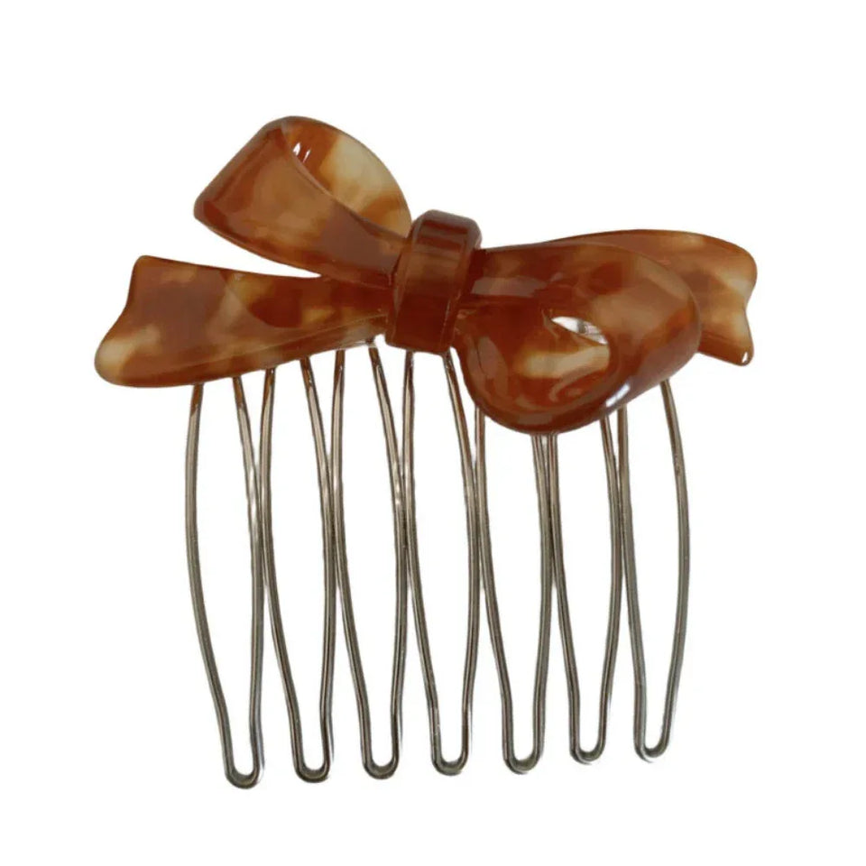 A single brown tortoiseshell bow hair comb against a white background. Main image