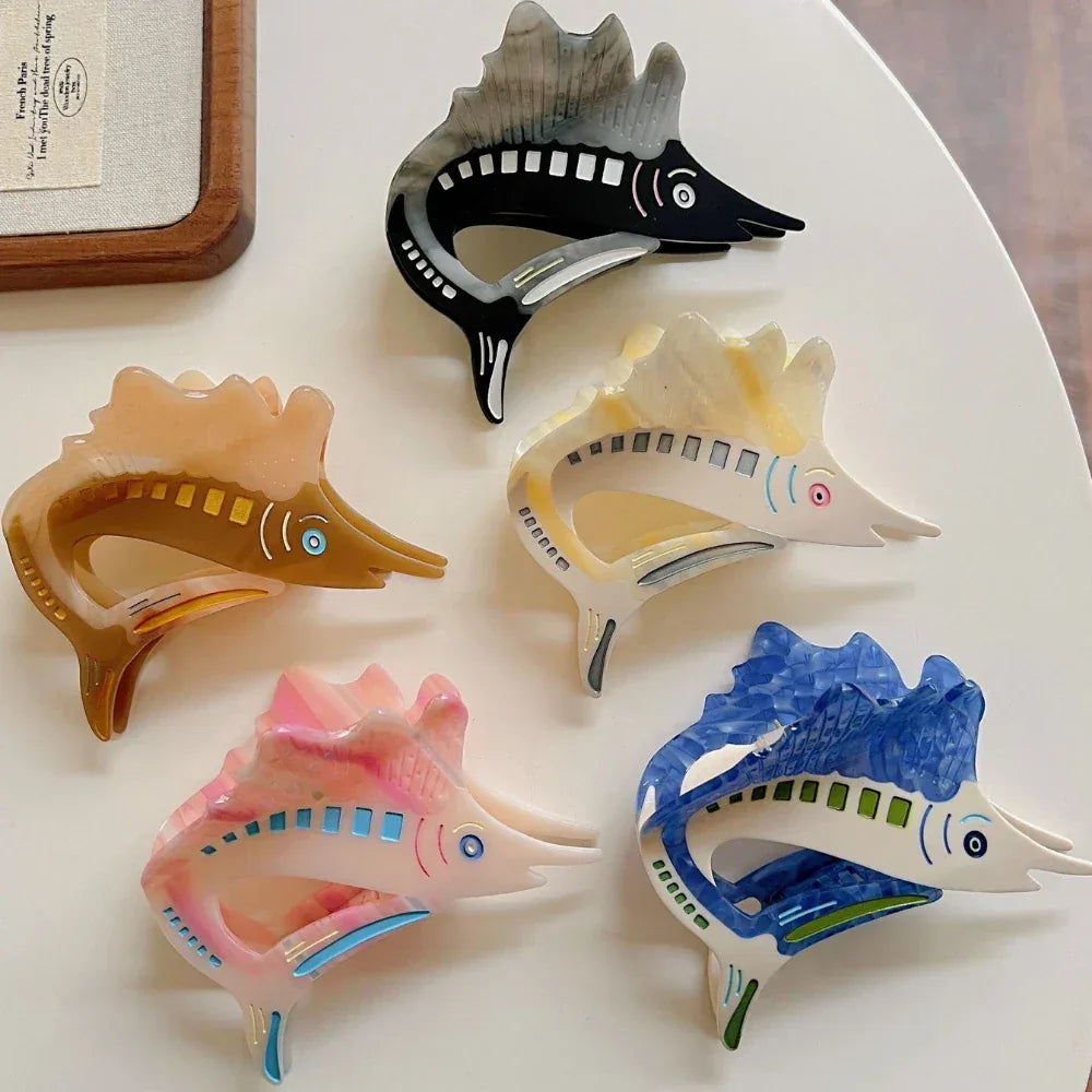 Collection of five marlin hair clips in various colors: brown, pink, black, yellow, and blue