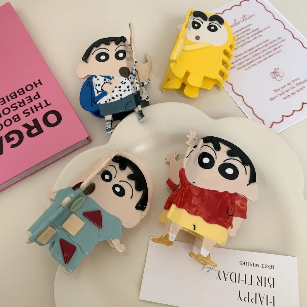 Collection of Shin Chan character figurines arranged on a surface with other items