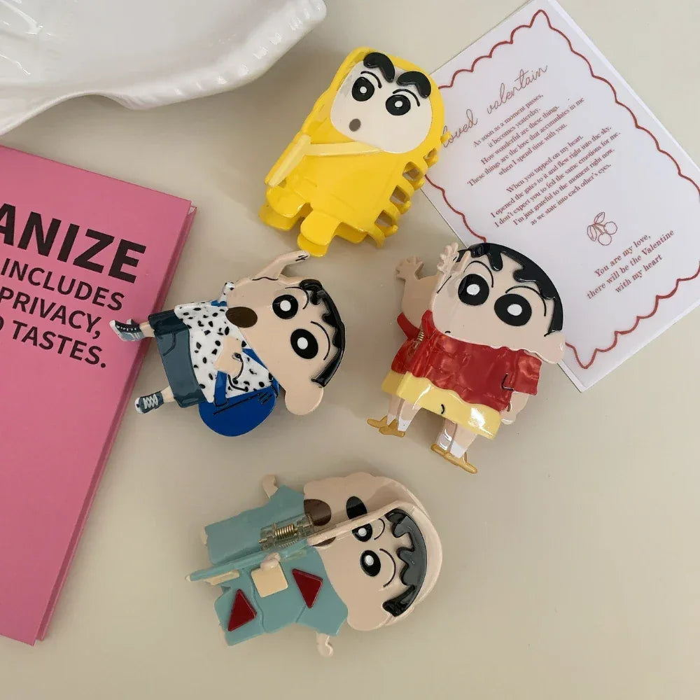 Close-up of Shin Chan character figurines with decorative cards and a book