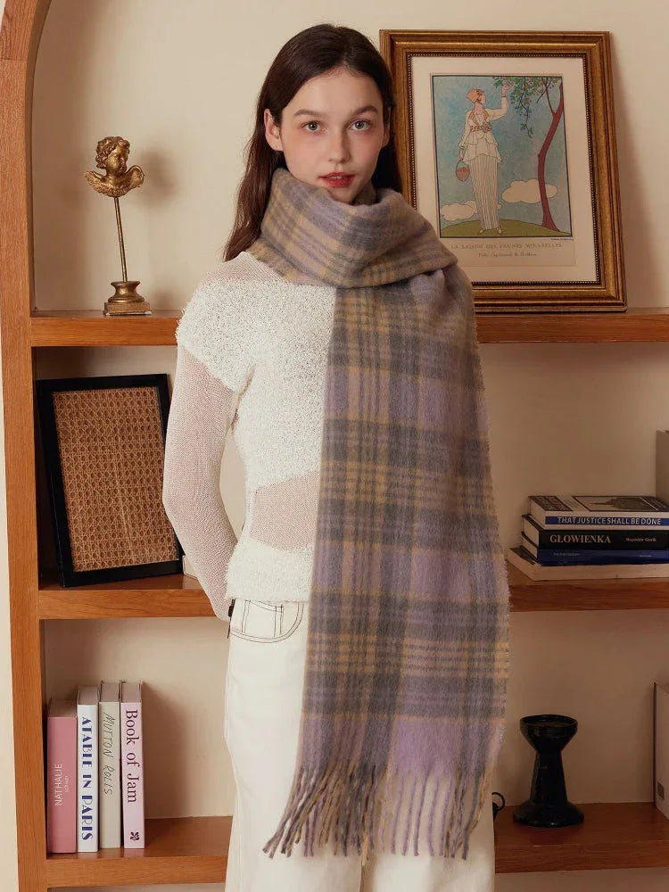 Model wearing a light purple and tan plaid scarf with fringe