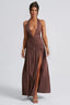 woman wearing a brown halter maxi dress with a deep v-neckline and high slit