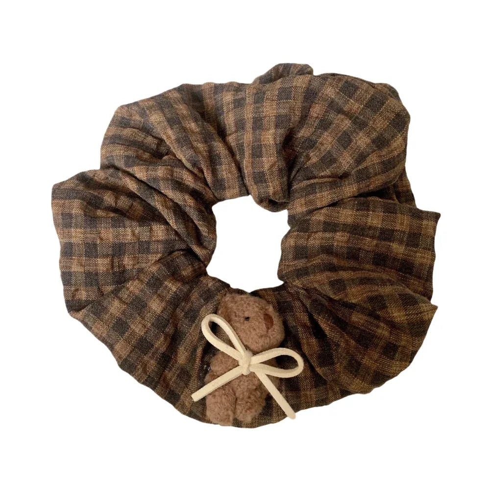 brown and black plaid scrunchie with a small teddy bear and white bow