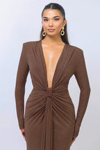 Close-up of the deep V-neckline and knot detail on a brown sparkly dress