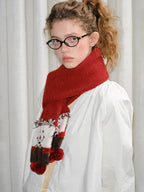 Full body shot of a young woman in a white outfit and a red scarf.