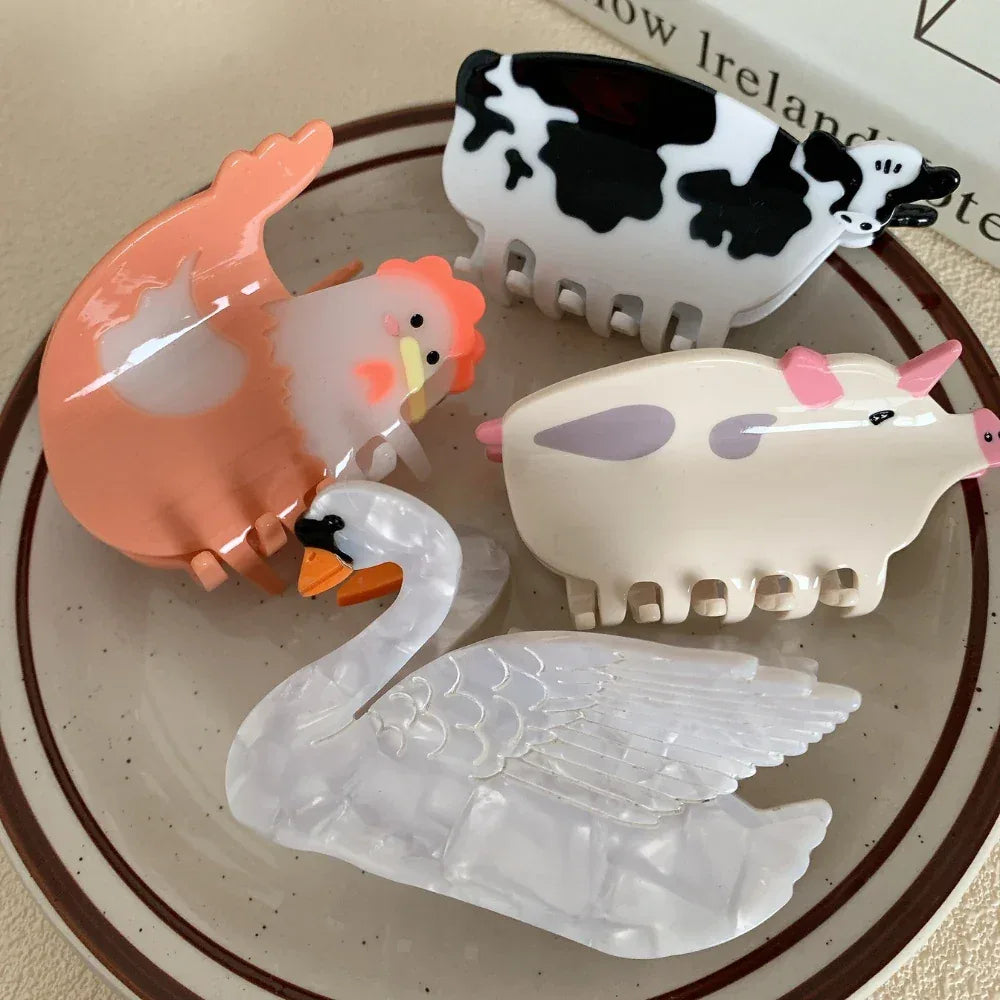 Assortment of farm animal and swan hair clips on a plate