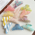 Group of decorative hair claw clips in different designs and colors