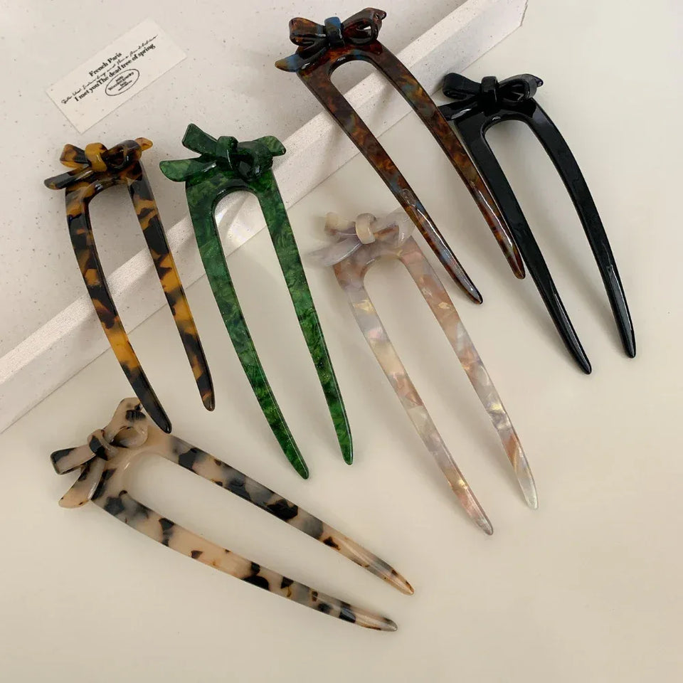 Collection of U-shaped hair forks with bow accents in various colors and patterns Secondary image
