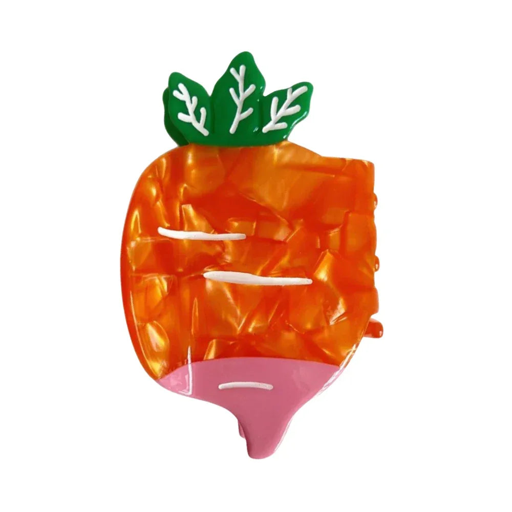 Orange carrot-shaped hair clip with green leaves and pink bottom.