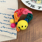 Braided terry cloth hair tie with a yellow smiley face charm - View 7 | TEVQA