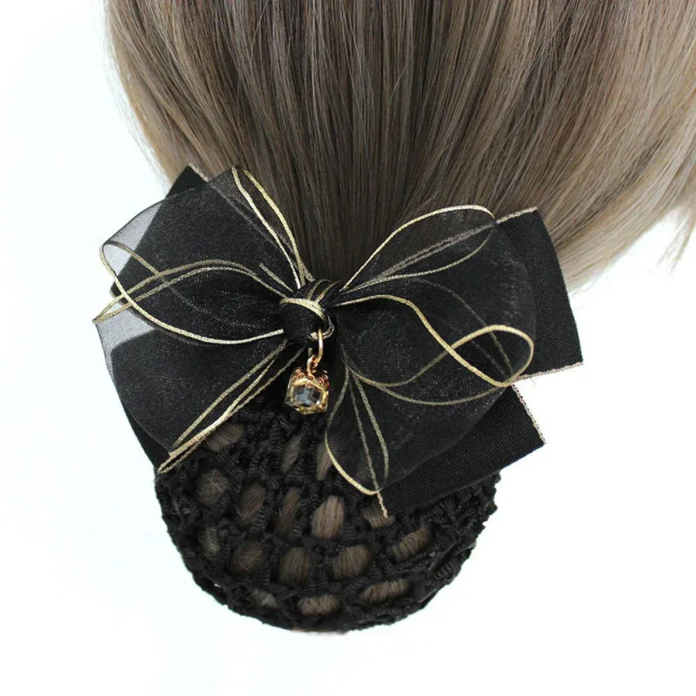 black hair bun cover with a black sheer organza bow with gold trim and charm on a mannequin head