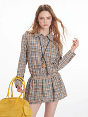Close-up of model wearing a plaid shirt dress and holding a yellow handbag