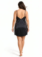Back view of a plus size black satin slip dress with lace details