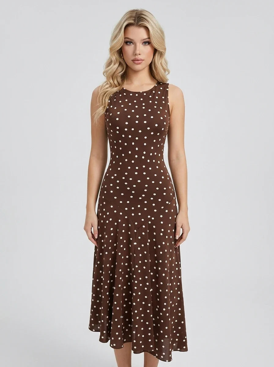 Woman wearing a brown polka dot midi dress, front view