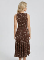 Woman wearing a brown polka dot midi dress, back view