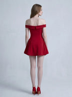 Back view of a woman in a red off-the-shoulder mini dress