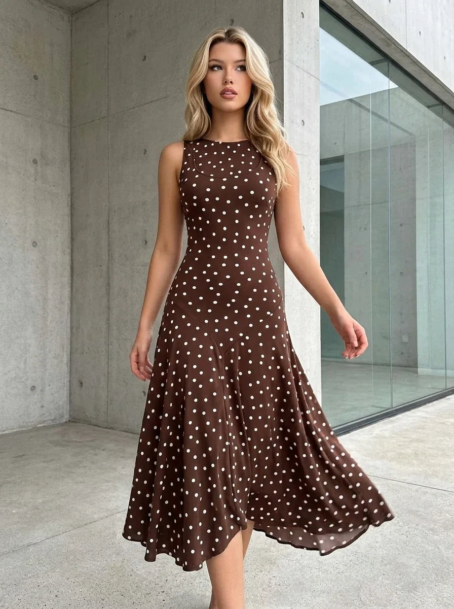 Woman wearing a brown polka dot midi dress in an outdoor setting